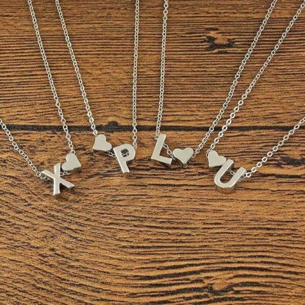 Four necklaces with the letters x, l, u and lu on them.