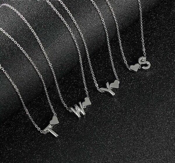 A set of sterling silver necklaces with initials on them.