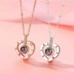 Two heart shaped necklaces with names on them.