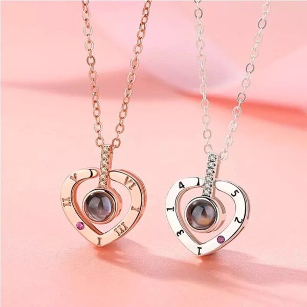 Two heart shaped necklaces with names on them.