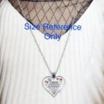 A necklace with a heart shaped pendant that says size reference only.