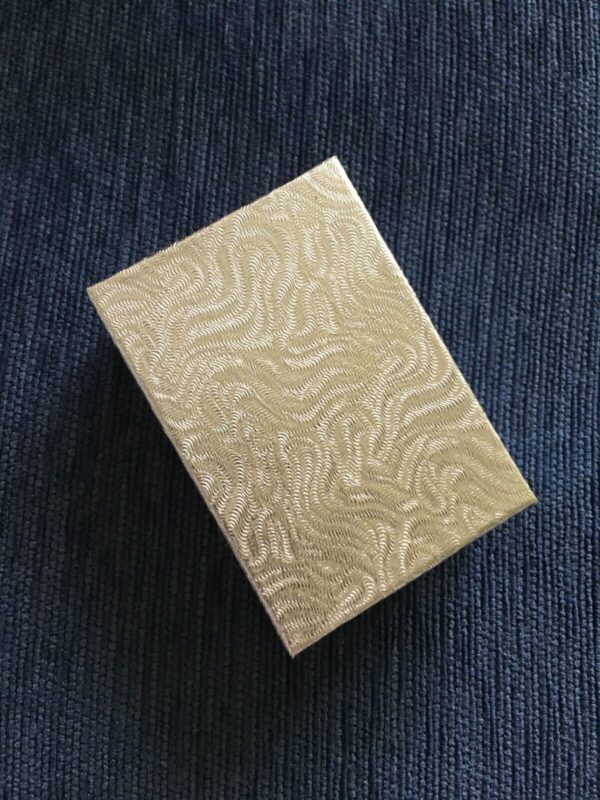 A gold box with a pattern on it.
