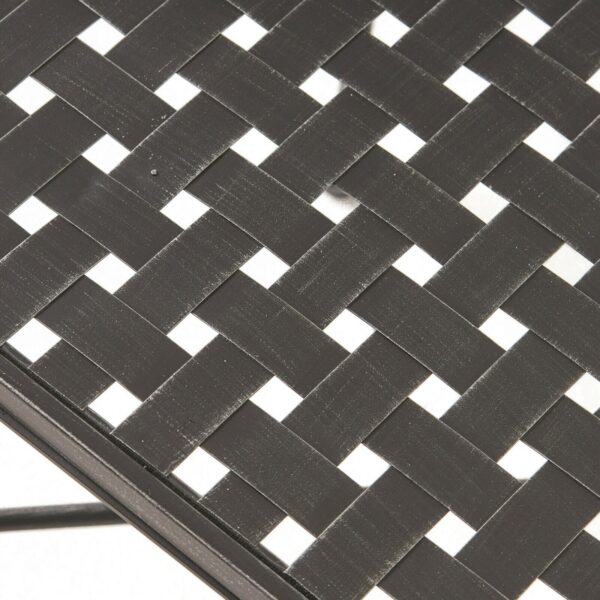 A close up of a black and white woven table.