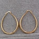 A pair of gold plated hoop earrings.