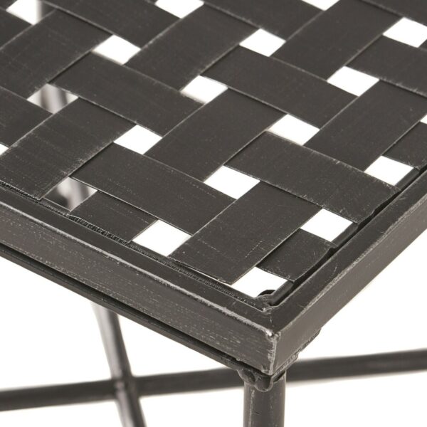 A black metal table with a woven pattern.