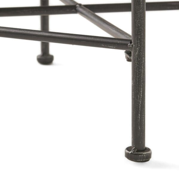A close up of a black metal stool.