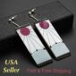 A pair of white and pink earrings with the words usa fast shipping.