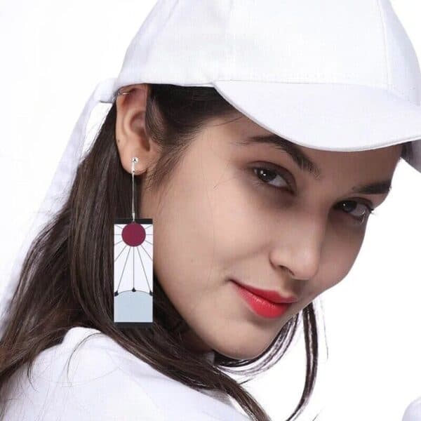 A woman wearing a white hat and a pair of earrings.