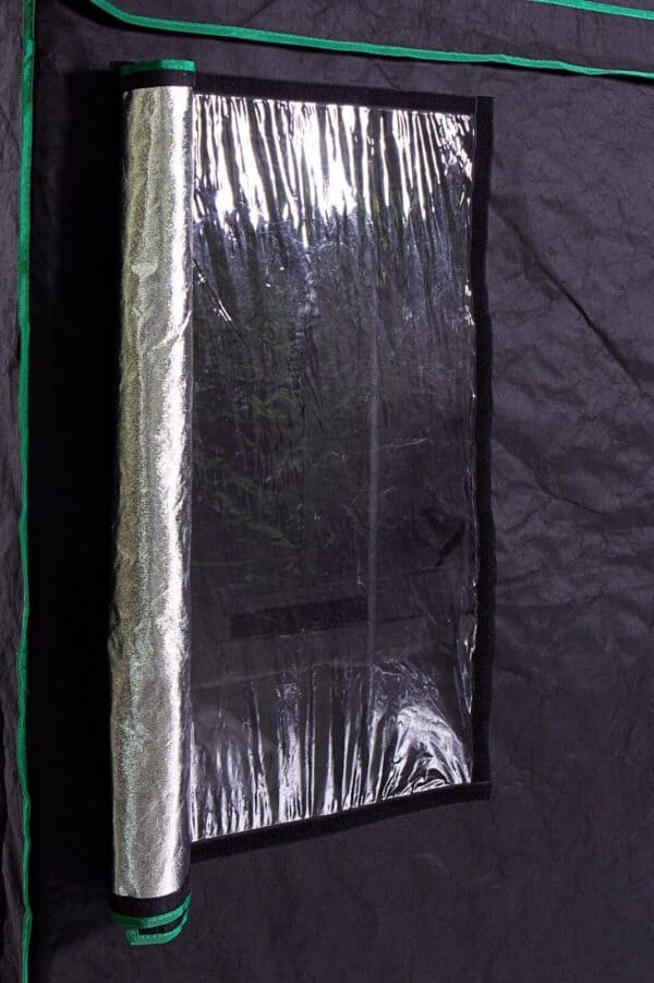 A black tent with a roll of foil on it.