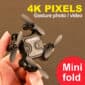 A person is holding a drone with the words 4k pixels gesture photo mini fold.