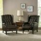 Two brown leather recliners in a living room.