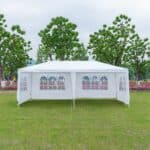 A white tent in a grassy area.