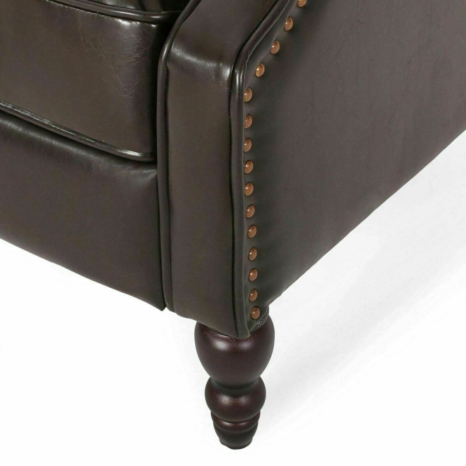 A brown leather chair with studding on the legs.