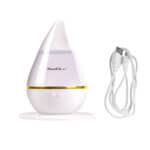 A white and gold humidifier with a cord.