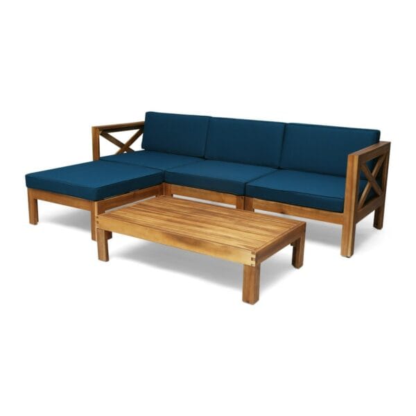 A teak sectional sofa with blue cushions and coffee table.