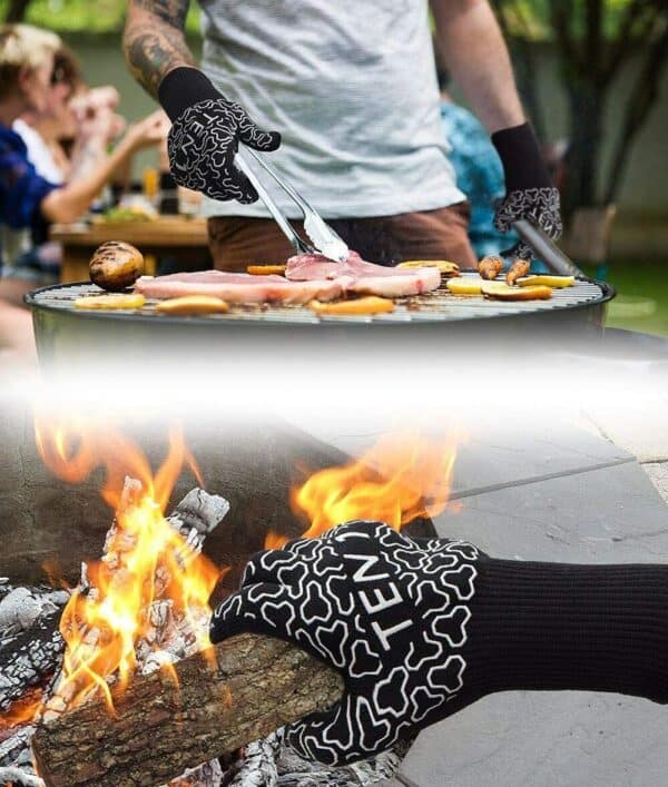 A man is grilling on a fire with a pair of gloves.