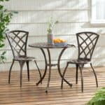 A table and chairs on a wooden deck.