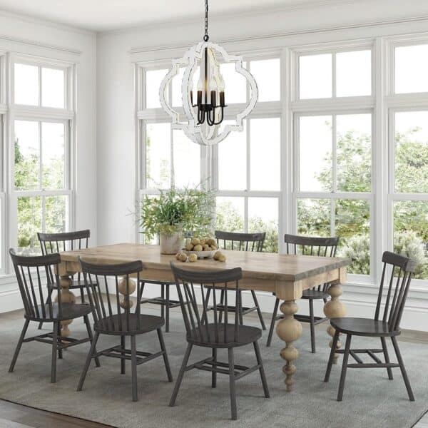 A bright dining room with large windows, a wooden table, gray and wood chairs, and a 21.7" Farmhouse Wood Chandelier Light Fixture, Handmade Distressed White Geometric Hanging Pendant Lighting.