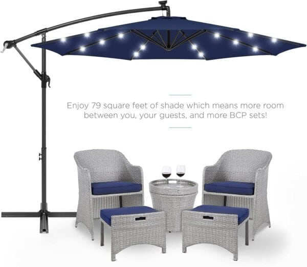 10ft Solar LED Offset Hanging Market Patio Umbrella w/Easy Tilt Adjustment Polyester Shade 8 Ribs with a table and four chairs with cushions, depicted in an advertisement highlighting ample shade.