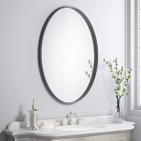 Black Oval Shape Mirror On A Beige Wall