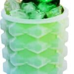 A green soda can surrounded by ice cubes from a Ice Cube Maker Silicone Bucket Mold Cooler With Free Ice Tray Cylinder, inside a translucent green honeycomb-patterned insulating sleeve.