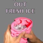 Hands squeezing a pink, flexible ice cube tray to release ice cubes into the container, with the caption "The Ultimate Mini Ice Cube Maker Pink Silicone Bucket Ice Mold and Storage Bin Portable 2 in 1 Ice Cube Maker" at the top.