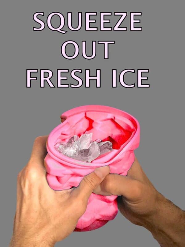 Hands squeezing a pink, flexible ice cube tray to release ice cubes into the container, with the caption "The Ultimate Mini Ice Cube Maker Pink Silicone Bucket Ice Mold and Storage Bin Portable 2 in 1 Ice Cube Maker" at the top.