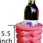 A wine bottle placed within a pink, 5.5-inch accordion-style silicone wine cooler, accompanied by The Ultimate Mini Ice Cube Maker Pink Silicone Bucket Ice Mold and Storage Bin Portable 2 in 1 Ice Cube Maker.