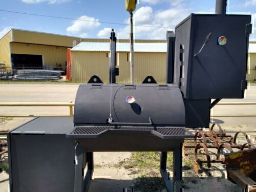 A large black Custom Made Heavy Duty BBQ Smoker Grill Steel on Casters Outdoor outside a business, featuring multiple compartments and a chimney, with a street and buildings in the background.