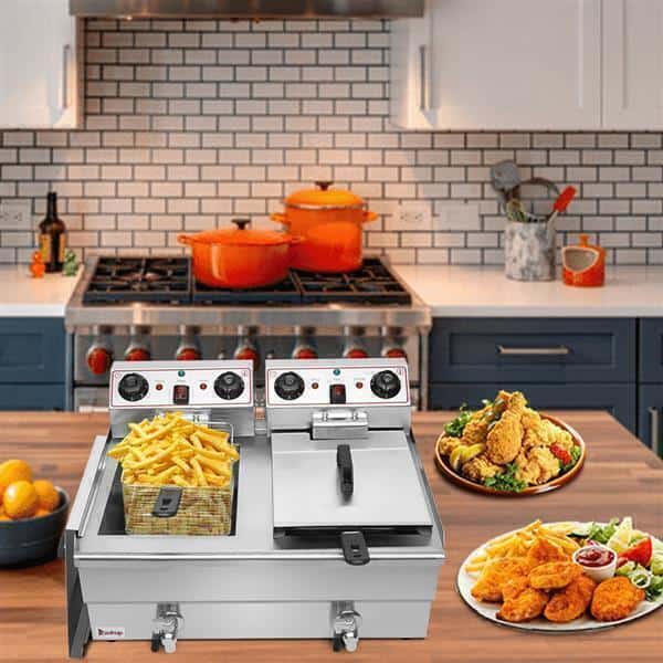 Modern kitchen with a ZOKOP 24.9QT Stainless Steel Faucet Double Cylinder Electric Fryer, stove, pots, and prepared food including fried chicken and fries.