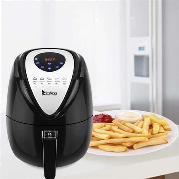 A black ZOKOP 120V 1500W 2.85QT/2.7L air fryer computer model with a digital display on a kitchen counter, next to a plate of french fries with ketchup and mayonnaise.